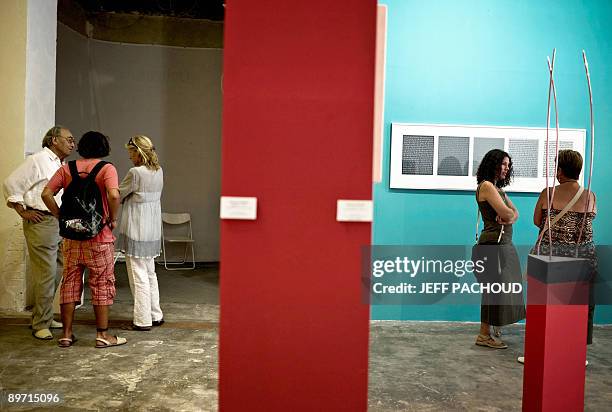 People attend a "Op art" or optical art exhibition on August 6, 2009 in the Franck Popper contemporary art center in Marcigny, eastern France where...