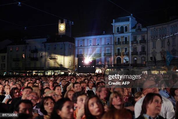 Spectators watch a movie on the Piazza Grande during the 62nd Locarno international film festival on late August 8, 2009 in Locardo. The Locarno film...