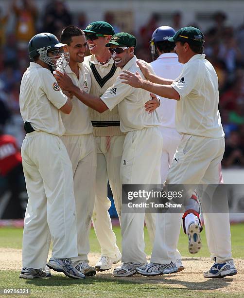 Mitchell Johnson of Australia celebrates with his team mates after taking the match winning wicket of Graham Onions of England to square the series...