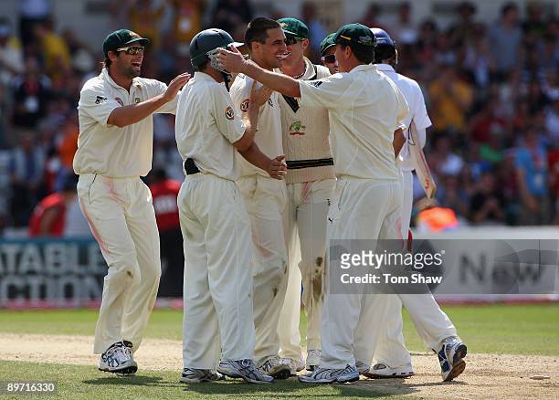 Mitchell Johnson of Australia celebrates with his team mates after taking the match winning wicket of Graham Onions of England to square the series...