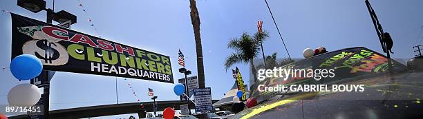 By Rob Lever, US-economy-auto-politics A Ford car dealer in Marina del Rey, California, offers the "Cash for Clunkers" program to customers on August...