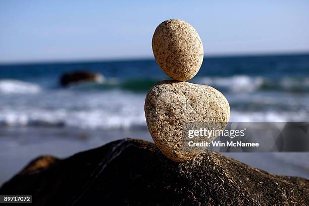 Two rocks balance upon a large stone at the Gay Head beach August 7, 2009 in Aquinnah, Massachusetts on the island of Martha's Vineyard. President...