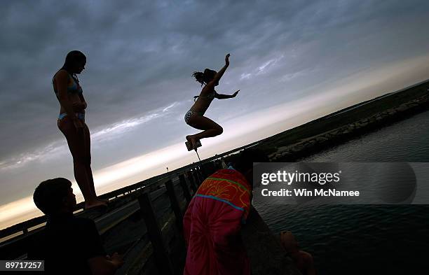 Young woman jumps from the American Legion Bridge as her family watches near State Beach on the road between Oak Bluffs and Edgartown August 6, 2009...