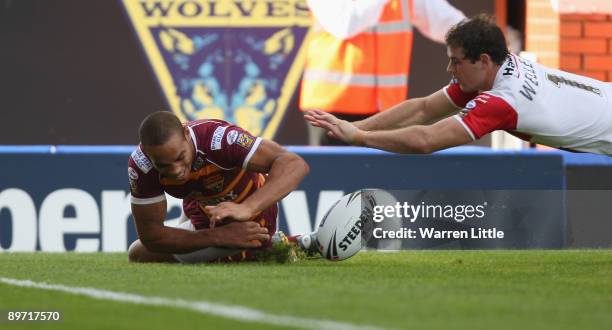 Leroy Cudjoe of Huddersfield dives over to score a try during the semi-final match of the Carnegie Challenge Cup between St Helens and Huddersfield...