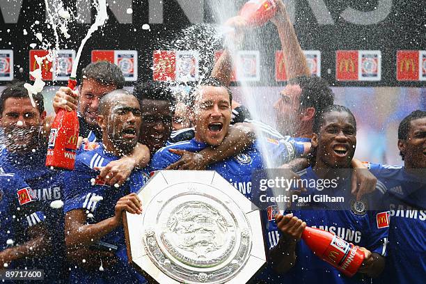 Captain John Terry of Chelsea leads the celebrations with the trophy after victory in the FA Community Shield match between Manchester United and...