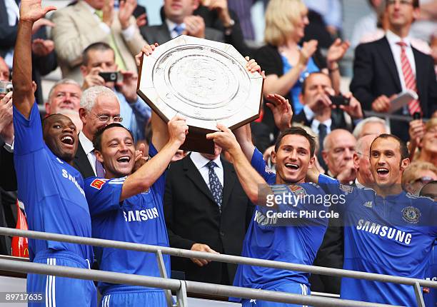 Didier Drogba, John Terry, Frank Lampard and Ricardo Carvalho of Chelsea celebrate with the trophy after victory during the FA Community Shield match...