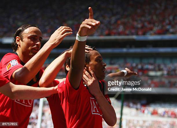 Luis Nani of Manchester United celebrates scoring the first goal of the game with Dimitar Berbatov during the FA Community Shield match between...