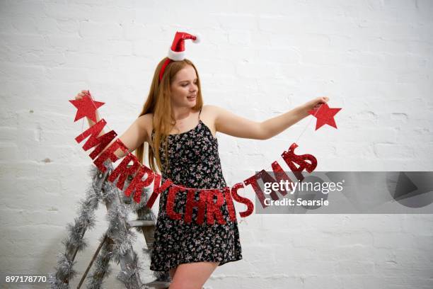 putting up christmas decorations merry christmas - searsie stock pictures, royalty-free photos & images