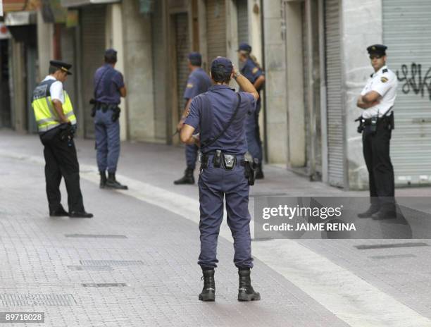 Policemen and Guardia Civil officers are pictured in a security perimeter around Major square in Palma de Mallorca on August 9, 2009 after a bomb...