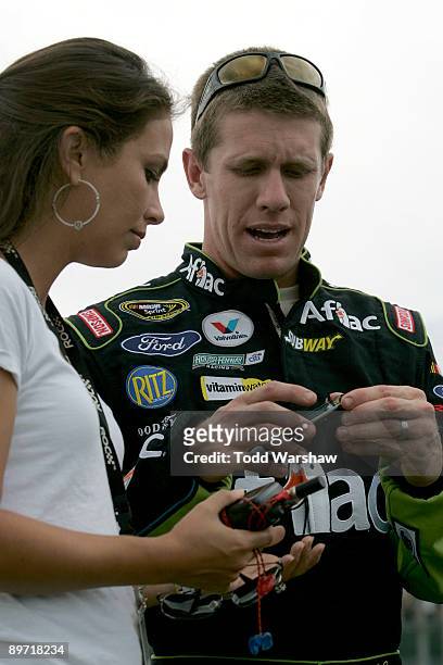 Carl Edwards , driver of the Aflac Ford, talks with his wife Katherine Downey on the grid prior to the NASCAR Sprint Cup Series Heluva Good! Sour...