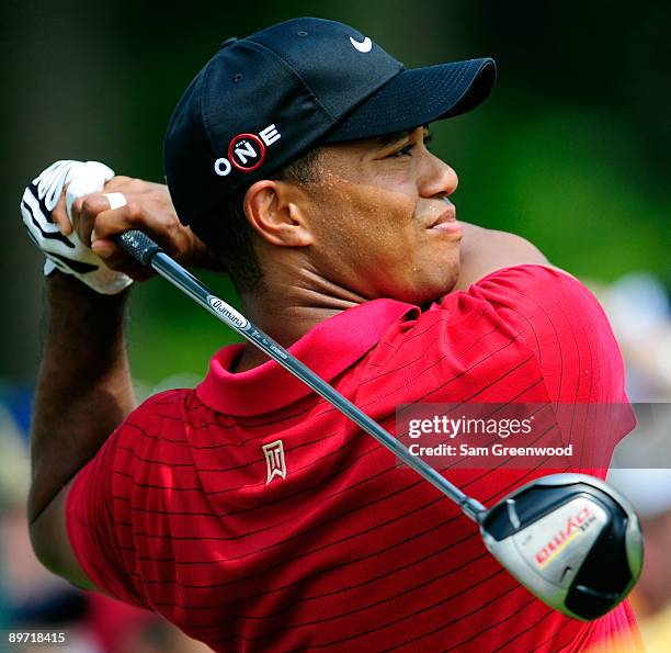 Tiger Woods plays a shot on the 4th hole during the final round of the WGC-Bridgestone Invitational on the South Course at Firestone Country Club on...