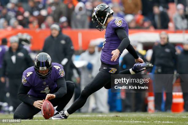 Sam Koch of the Baltimore Ravens holds the ball as Justin Tucker of the Baltimore Ravens kicks a field goal during the game against the Cleveland...