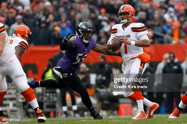DeShone Kizer of the Cleveland Browns is pressured by Terrell Suggs of the Baltimore Ravens during the game at FirstEnergy Stadium on December 17,...