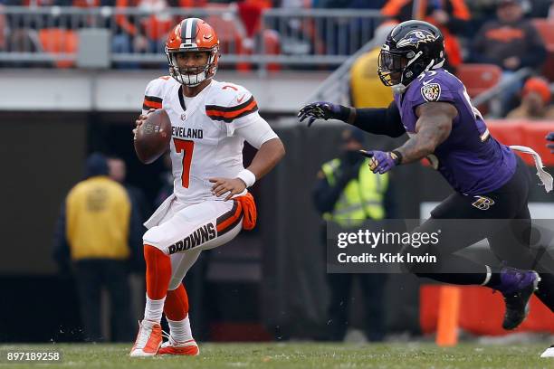 DeShone Kizer of the Cleveland Browns is pressured by Terrell Suggs of the Baltimore Ravens during the game at FirstEnergy Stadium on December 17,...