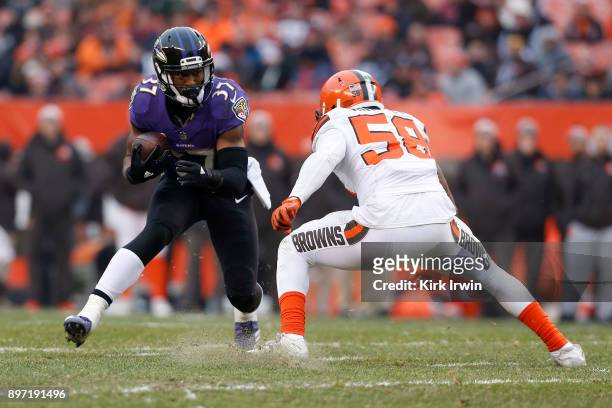 Javorius Allen of the Baltimore Ravens attempts to run the ball past Christian Kirksey of the Cleveland Browns during the game at FirstEnergy Stadium...