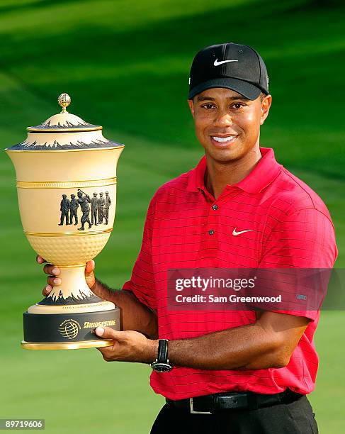 Tiger Woods holds the trophy after winning the WGC-Bridgestone Invitational on the South Course at Firestone Country Club on August 9, 2009 in Akron,...