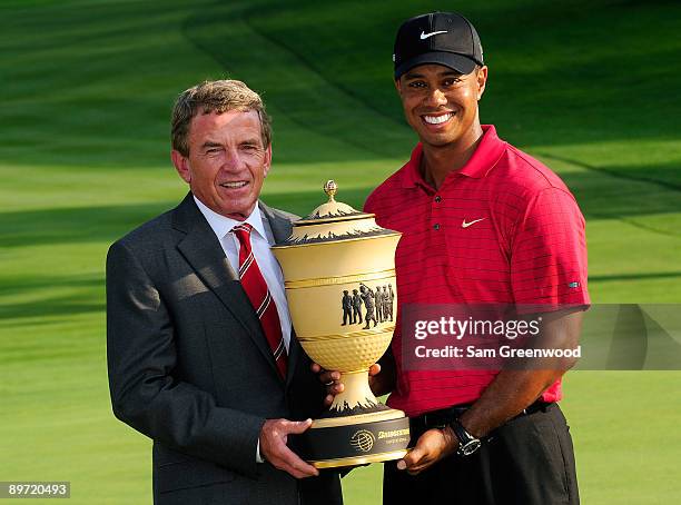 Tiger Woods and Tim Finchem, Commissioner of the PGA Tour, holds the Gary Player trophy following the final round of the WGC-Bridgestone Invitational...