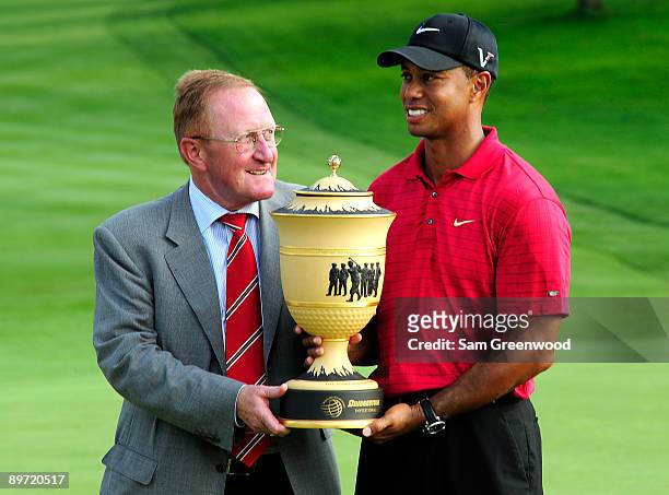 Richard Hills, Ryder Cup Director and Tiger Woods hold the Gary Player trophy following the final round of the WGC-Bridgestone Invitational on the...