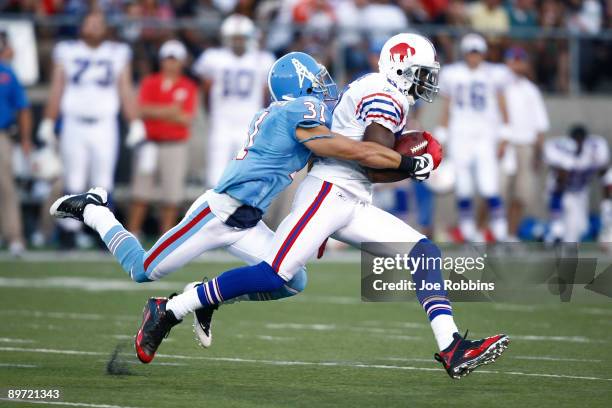 Terrell Owens of the Buffalo Billls runs with the football after catching a pass in front of Cortland Finnegan of the Tennessee Titans during the Pro...