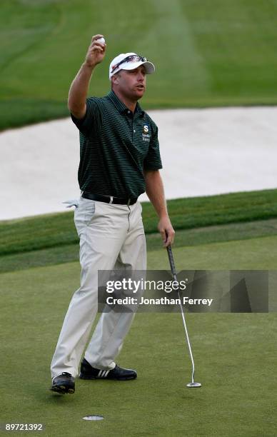 John Rollins waves to the crowd after sinking a par putt to win the Legends Reno-Tahoe Open on August 9, 2009 at Montreux Golf and Country Club in...