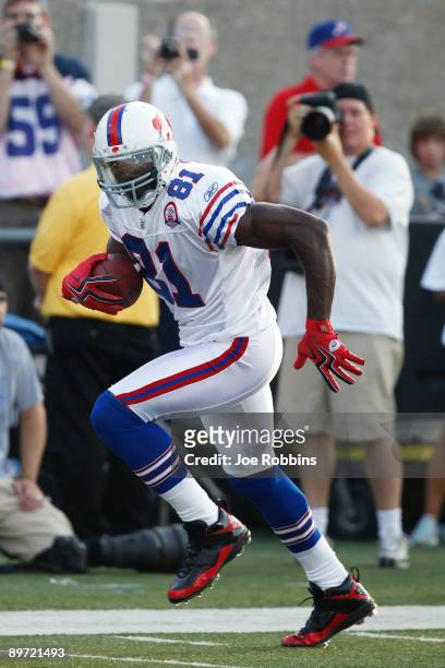 Terrell Owens of the Buffalo Bills runs with the football against the Tennessee Titans during the Pro Football Hall of Fame Game at Fawcett Stadium...