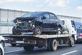 wrecker transports broken car
