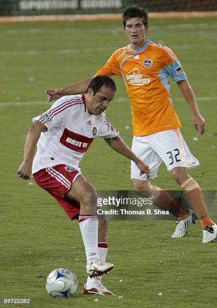 Bobby Boswell of the Houston Dynamo plays defense against Cuauhtemoc Blanco of the Chicago Fire at Robertson Stadium on August 9, 2009 in Houston,...