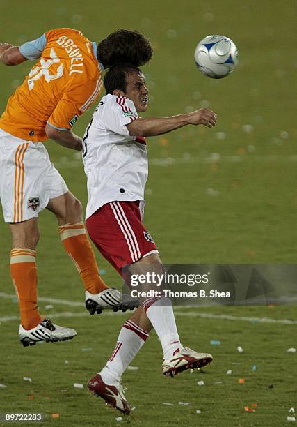 Bobby Boswell of the Houston Dynamo heads the ball against Cuauhtemoc Blanco of the Chicago Fire at Robertson Stadium on August 9, 2009 in Houston,...
