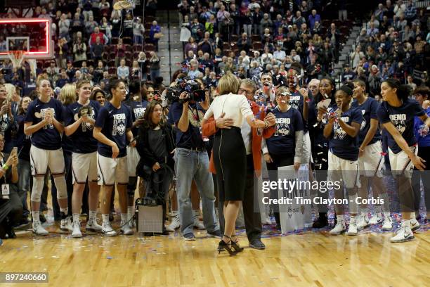 Head coach Geno Auriemma of the UConn Huskies and assistant coach Chris Daley embrace after recorded their 1000th win as head coach and assistant...