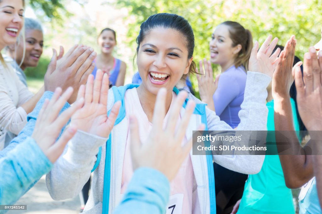 Ecstatic woman is congratulated after charity race