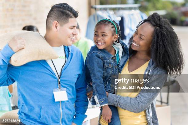 diverse family donates items during food drive - disaster preparation stock pictures, royalty-free photos & images