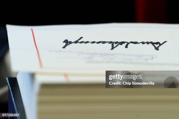 Sweeping new tax reform legislation bears U.S. President Donald Trump's signature in the Oval Office at the White House December 22, 2017 in...