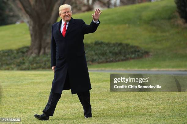 President Donald Trump waves to journalists as he leaves the White House December 22, 2017 in Washington, DC. Trump is leaving Washington to spend...