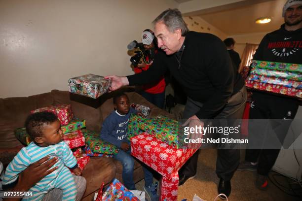 Ernie Grunfeld of the Washington Wizards helps hands out presents during the Washington Wizards Holiday Event on December 20, 2017 in Washington, DC....