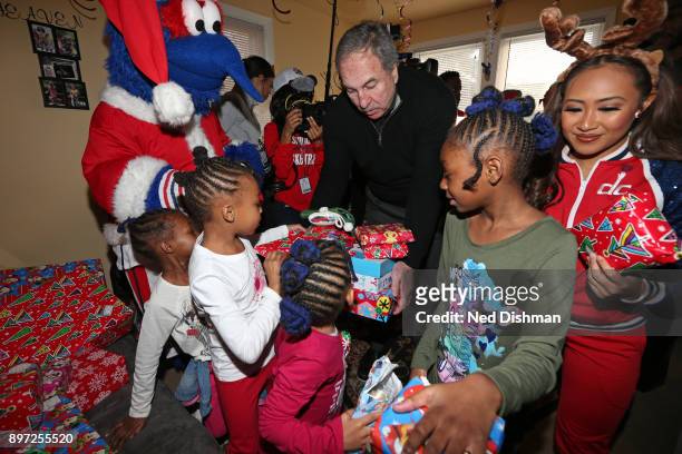 Ernie Grunfeld of the Washington Wizards helps hands out presents during the Washington Wizards Holiday Event on December 20, 2017 in Washington, DC....