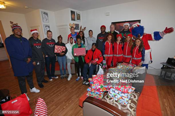 The Washington Mystics and Washington Wizards help hand out presents during the Washington Wizards Holiday Event on December 20, 2017 in Washington,...