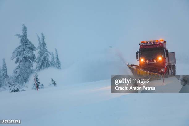 snowblower grader clears snow covered country road - sneeuwmachine stockfoto's en -beelden