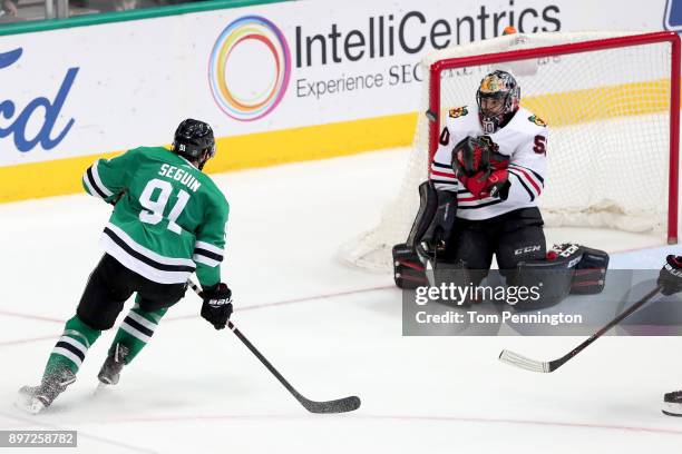 Corey Crawford of the Chicago Blackhawks blocks a shot against Tyler Seguin of the Dallas Stars in the third period at American Airlines Center on...