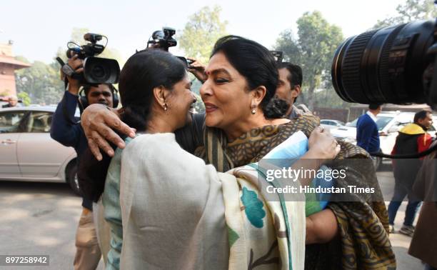 Leader Kanimozhi being greeted by Congress leader Renuka Chowdhury during the on-going winter session of Parliament house on December 22, 2017 in New...