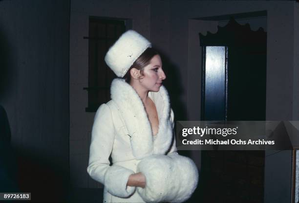 American actress and singer Barbra Streisand dressed in white with a mink fur hat and trimmings, December 1969.