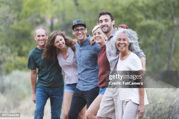 friends of all ages - smiling friends interacting outside stock pictures, royalty-free photos & images