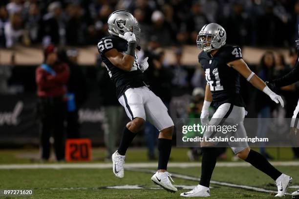 Xavier Woodson-Luster and Erik Harris of the Oakland Raiders celebrate after making a defensive play against the Dallas Cowboys at Oakland-Alameda...