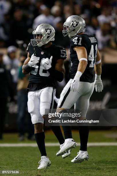 Xavier Woodson-Luster and Erik Harris of the Oakland Raiders celebrate after making a defensive play against the Dallas Cowboys at Oakland-Alameda...