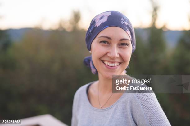 beautiful woman with cancer smiles - cancer illness stock pictures, royalty-free photos & images
