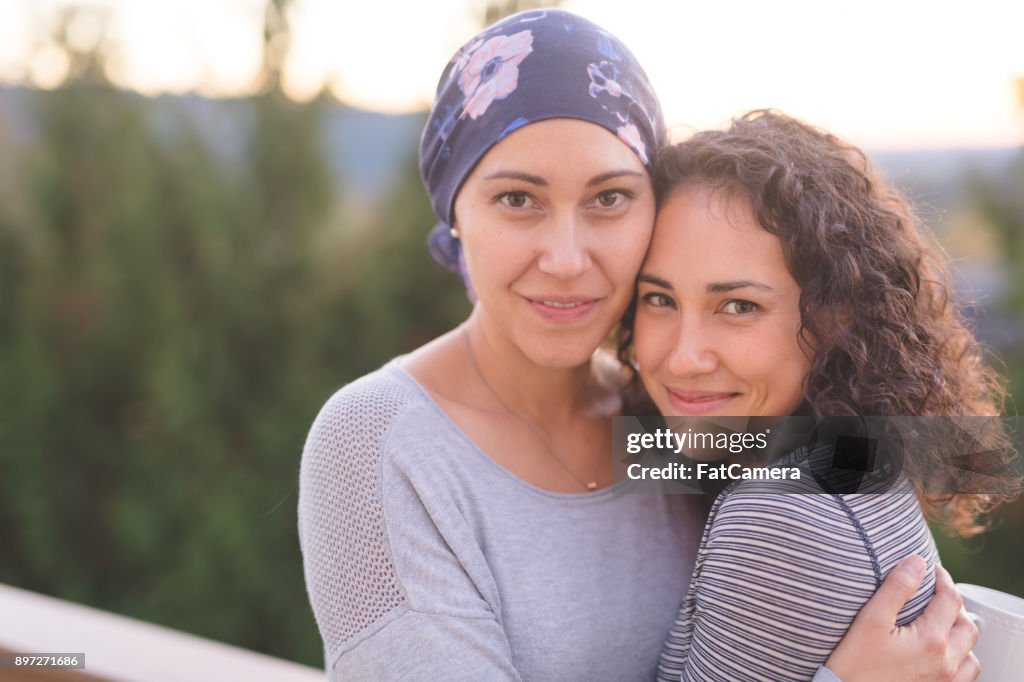 Beautiful Woman with Cancer Hugs Her Sister