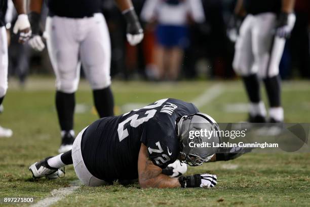 Donald Penn of the Oakland Raiders reacts after getting injured in a play during the game against the Dallas Cowboys at Oakland-Alameda County...