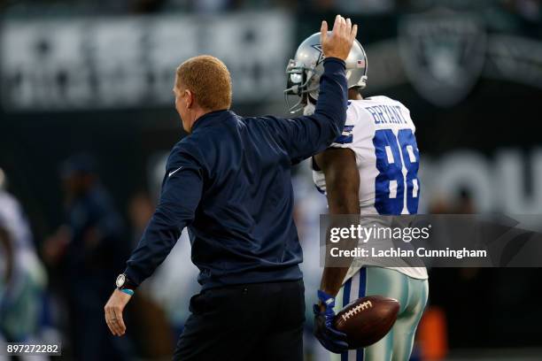 Head coach of the Dallas Cowboys, Jason Garrett, chats to Dez Bryant of the Dallas Cowboys during the warm up before the game against the Oakland...