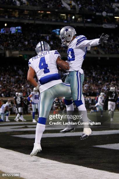 Quarterback Dak Prescott of the Dallas Cowboys celebrates with Terrance Williams after scoring a touchdown against the Oakland Raiders at...