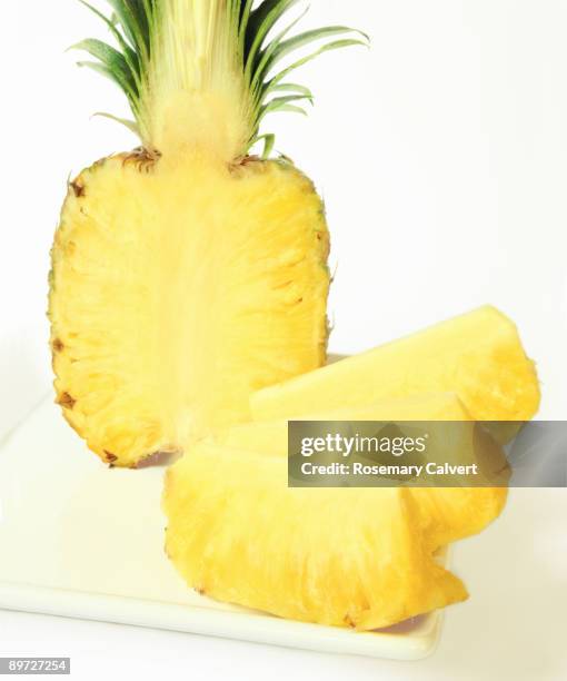 half a pineapple with four sections, close up. - ananas aufgeschnitten stock-fotos und bilder