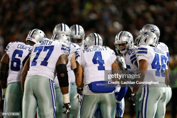 Quarterback Dak Prescott of the Dallas Cowboys calls a play in the huddle during the game against the Oakland Raiders at Oakland-Alameda County...